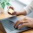 Man paying with credit card and entering security code for online shoping making a payment or purchasing goods on the internet with laptop computer, online shopping concept